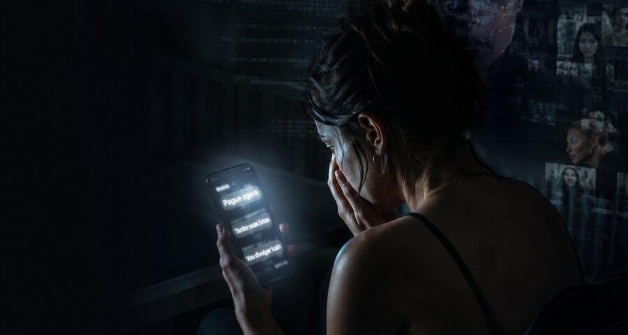 Pessoa assustada olhando celular após ameaça de sextorsão envolvendo deepfake e chantagem digital no Brasil.